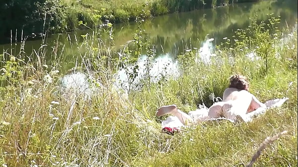 Nude Milf sunbathing on river bank. Random guy watching. Nudist beach. POV. Naked in public. Doggy style